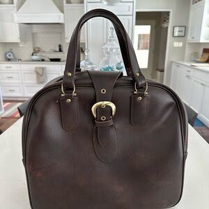 American Tourister Faux leather carry-on bag.